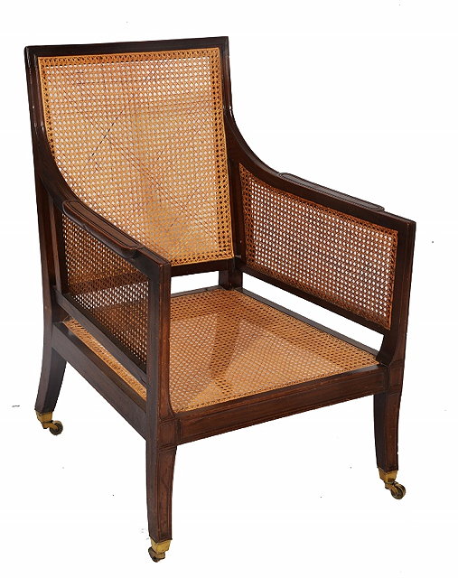 Appraisal: A REGENCY STYLE MAHOGANY BERGERE LIBRARY CHAIR with caned back