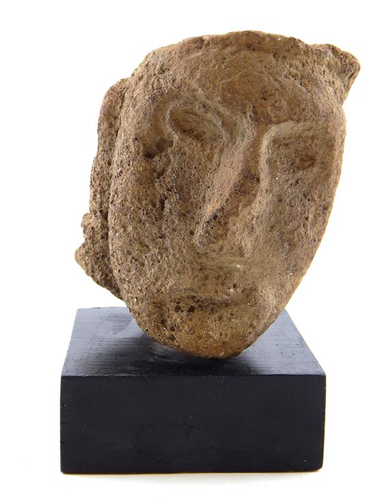 Appraisal: TRIBAL Pre-Columbian fragment of stone head carved from volcanic rock