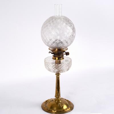 Appraisal: A brass and glass oil lamp with funnel shade and