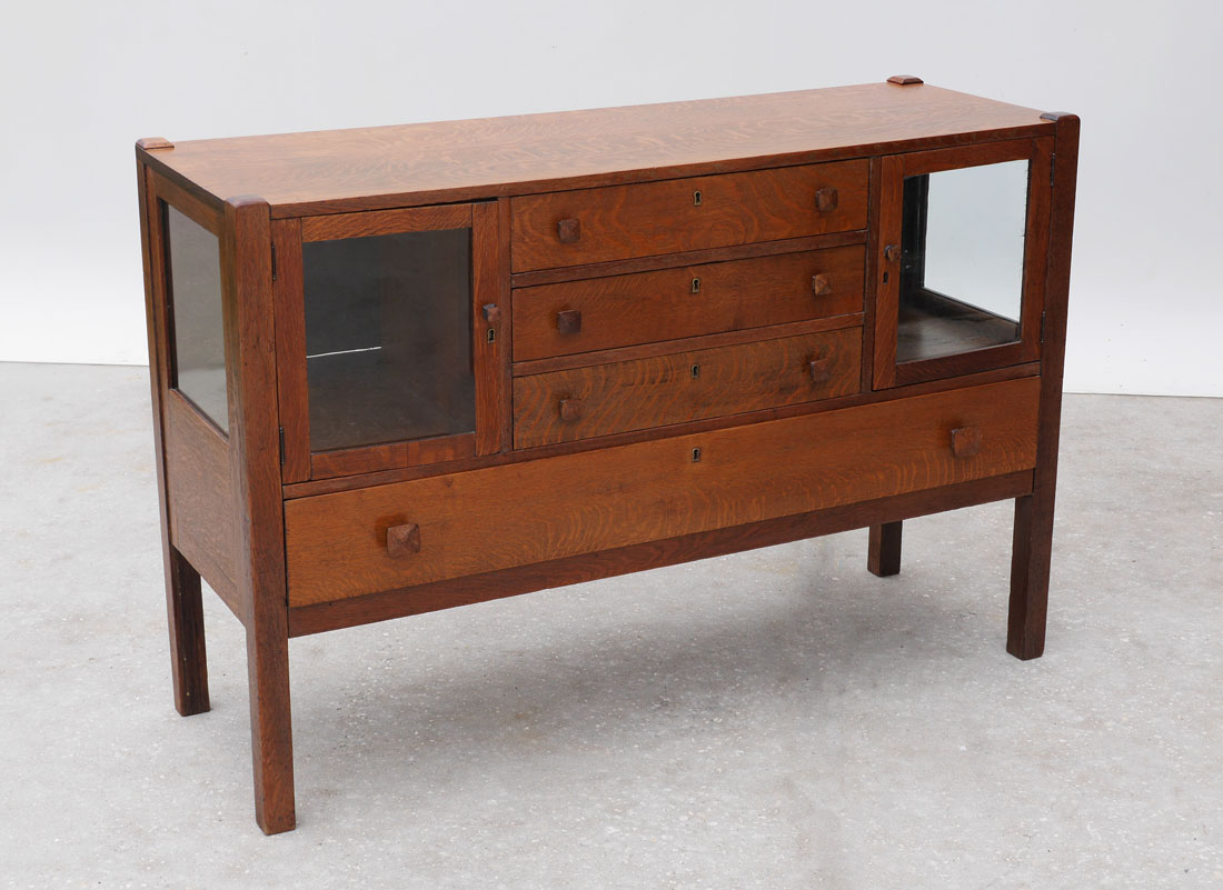 Appraisal: ARTS AND CRAFT OAK SIDEBOARD central drawers flanked by glass