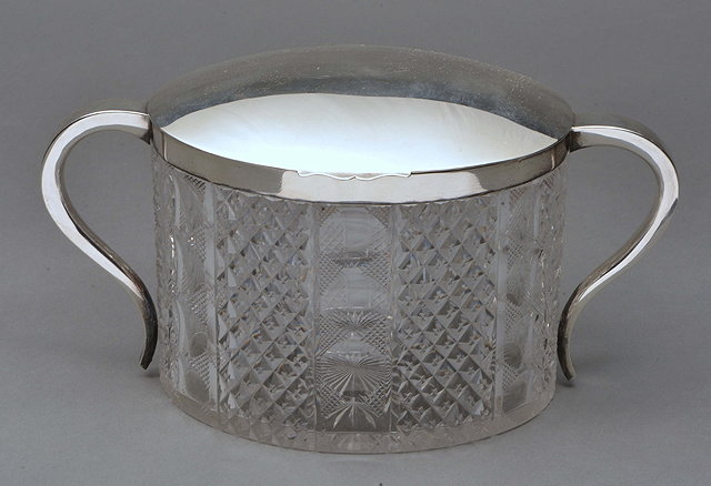 Appraisal: A SILVER MOUNTED CUT GLASS BISCUIT BARREL with shaped handles