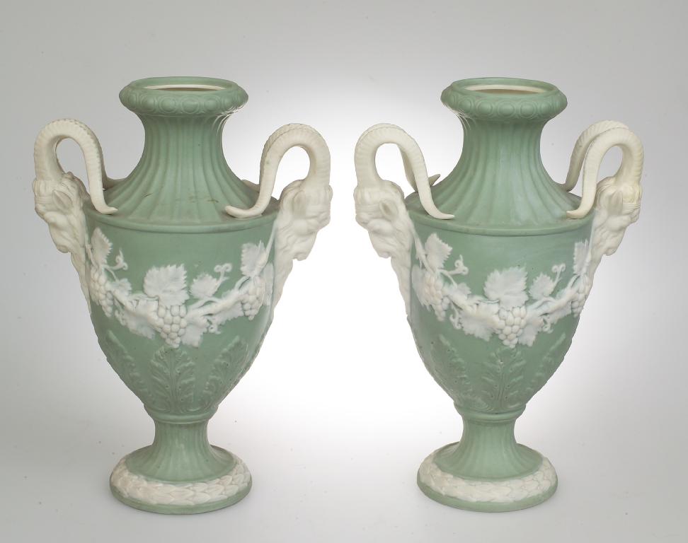 Appraisal: PAIR OF CONTINENTAL th CENTURY GREEN JASPERWARE TWO-HANDLED PEDESTAL VASES