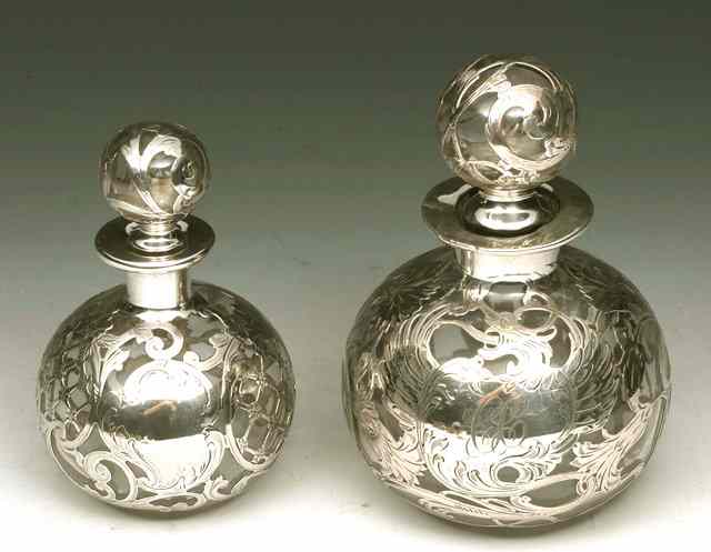 Appraisal: A SILVER AND GLASS OVERLAY PERFUME BOTTLE with pierced foliate