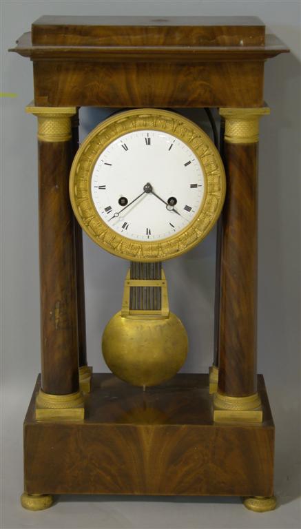 Appraisal: EMPIRE MAHOGANY AND GILT BRONZE-MOUNTED PORTICO CLOCK The porcelain chapter