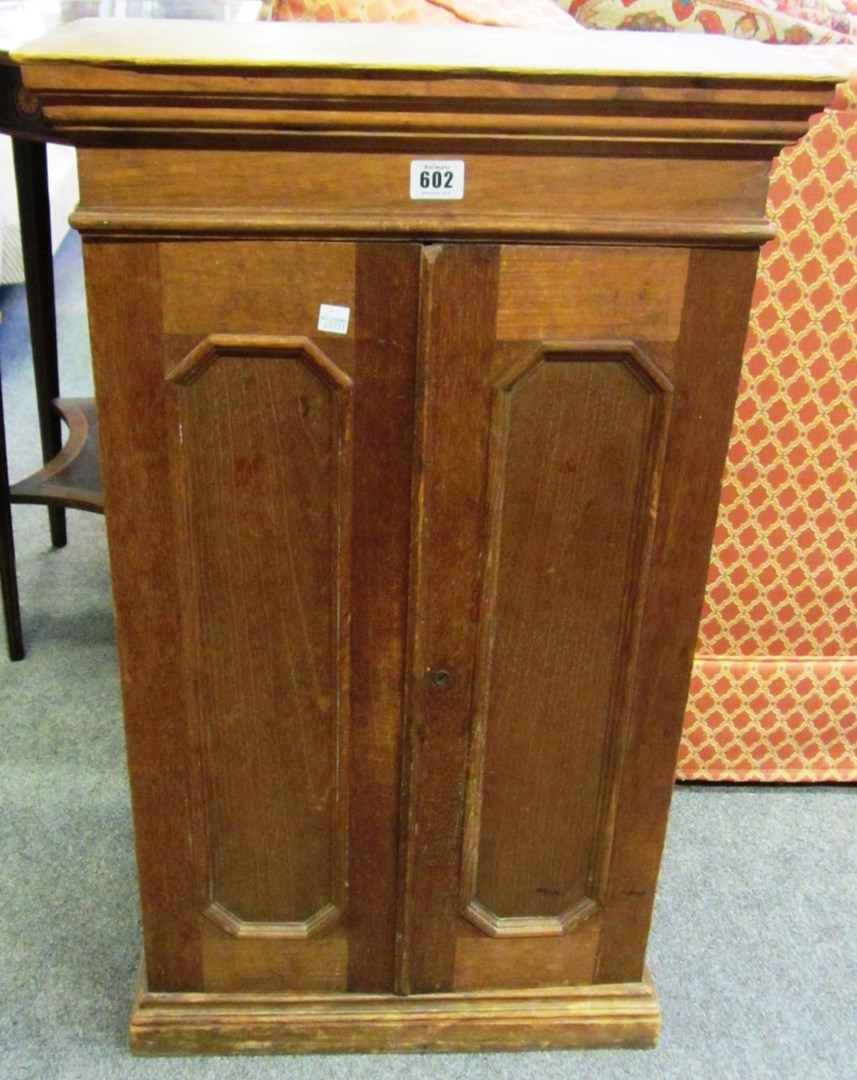 Appraisal: A th century hardwood two door cigar cabinet with embossed