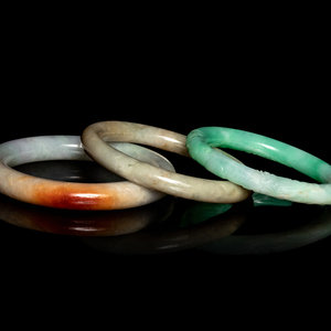 Appraisal: Three Chinese Jadeite Bangles each of cylindrical form comprising two