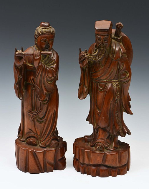 Appraisal: A PAIR OF CHINESE CARVED HARDWOOD FIGURES inscribed to the