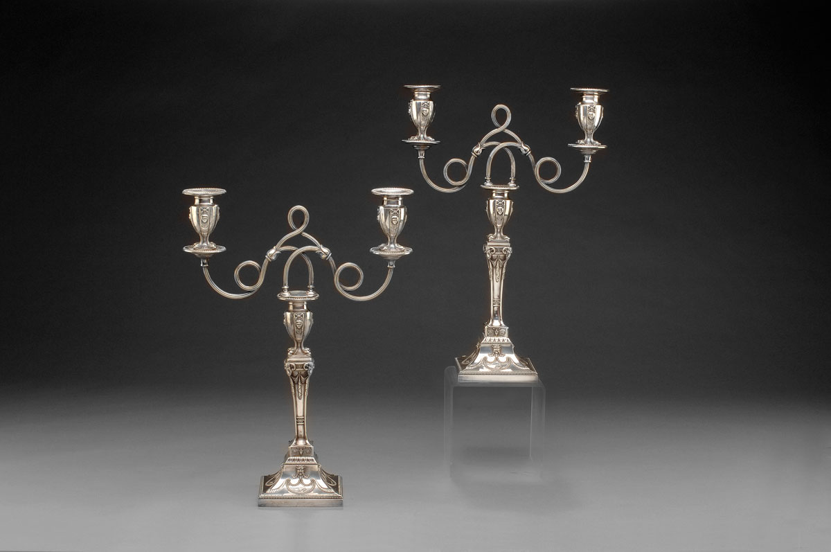 Appraisal: PAIR OF NEOCLASSICAL STYLE SILVERPLATE THREE- LIGHT CANDELABRA MAKER'S MARK