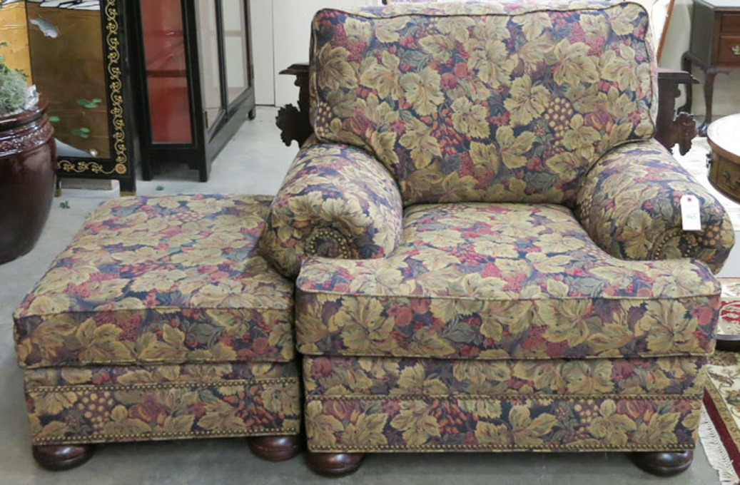 Appraisal: AN EASY CHAIR AND MATCHING OTTOMAN Norwalk Furniture Co handcrafted