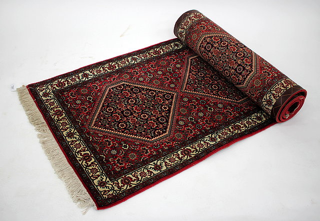 Appraisal: A MODERN ORIENTAL WINE GROUND RUNNER with five diamond designs