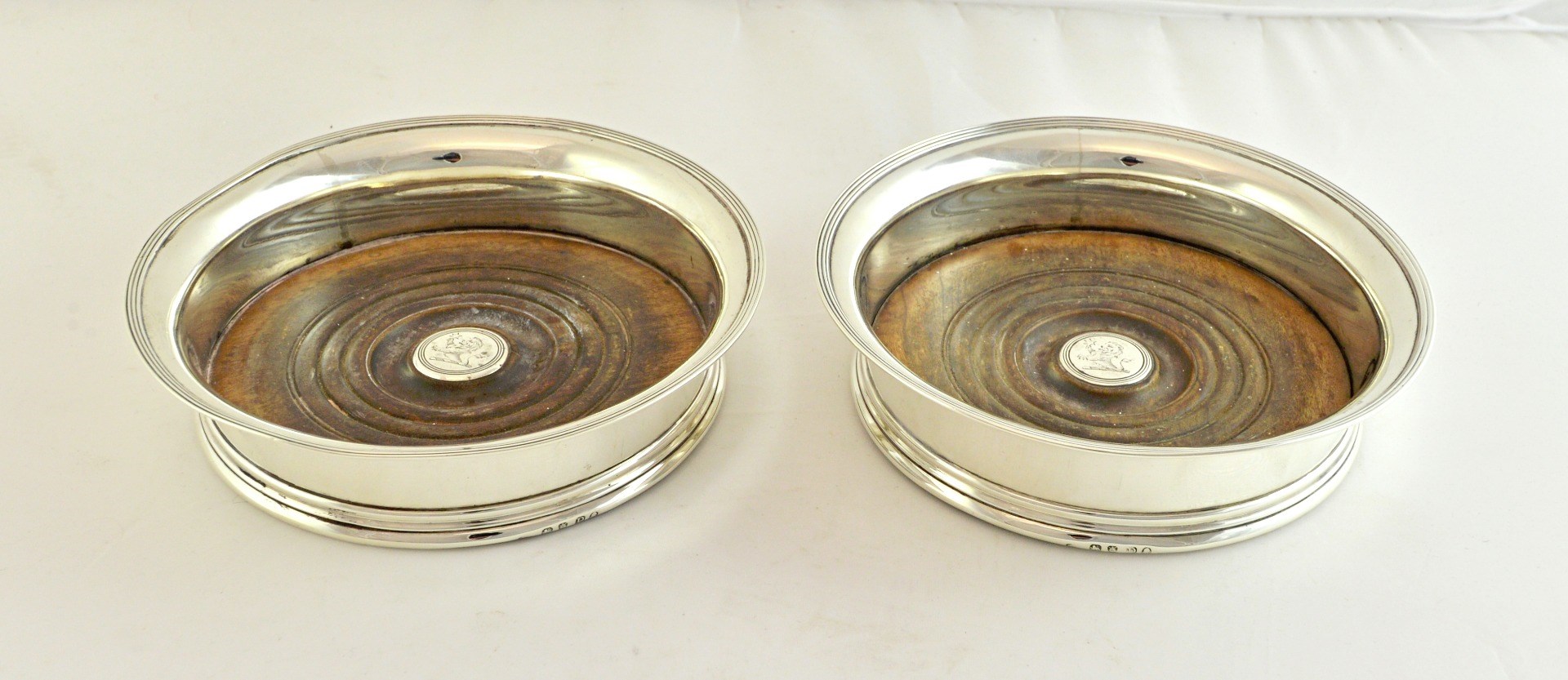 Appraisal: A pair of George III silver mounted bottle coasters each