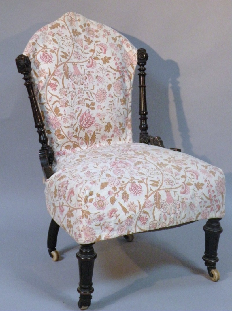 Appraisal: A Victorian ebonised nursing chair upholstered in later floral material