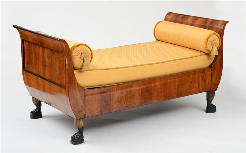 Appraisal: AUSTRIAN NEOCLASSICAL WALNUT EBONIZED AND PARCEL-GILT DAY BED The S-scroll