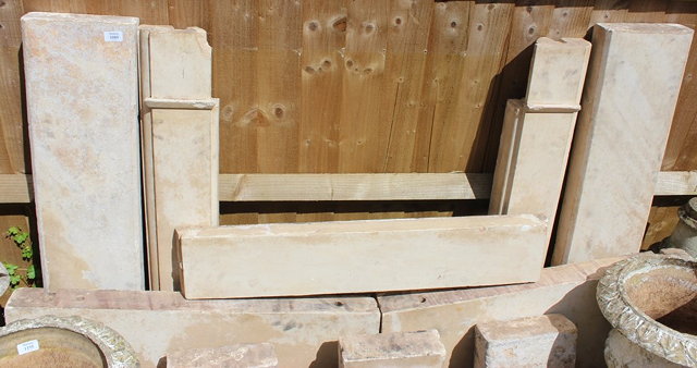 Appraisal: A COTSWOLD STONE FIRE SURROUND of shallow arch form standing