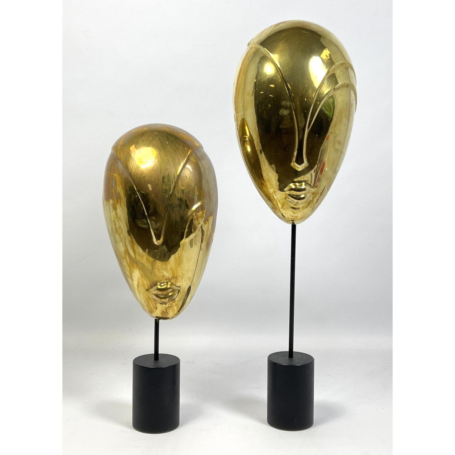 Appraisal: Pr BALOS Brass Hagenauer style face mask sculptures Shorter inches