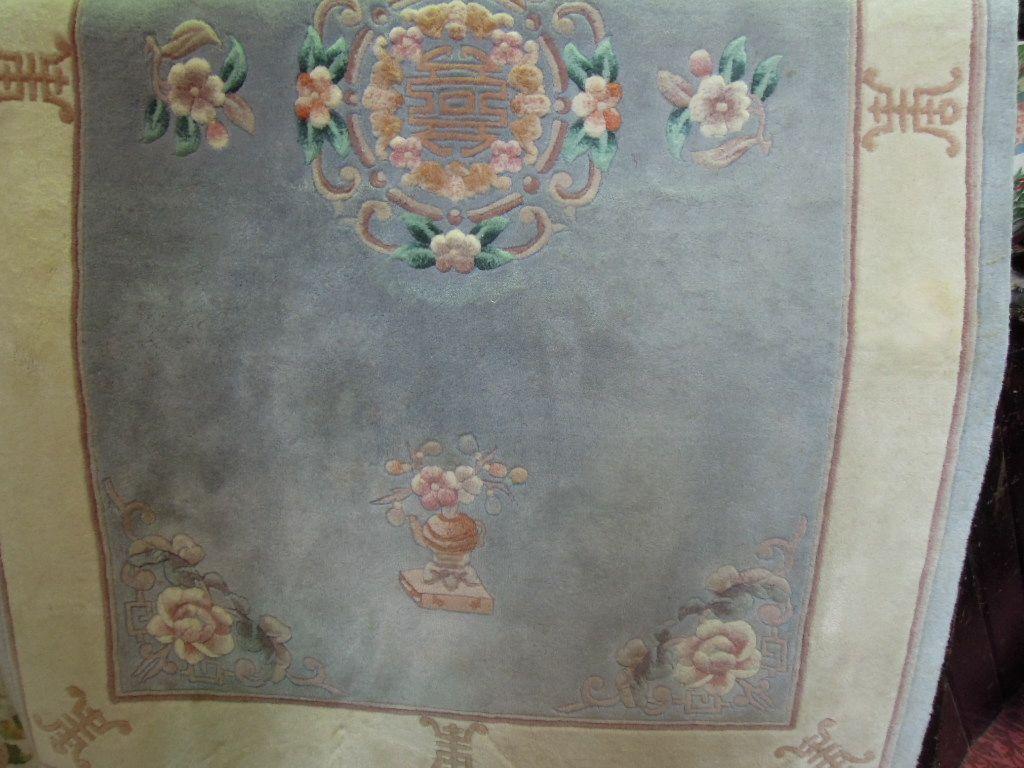 Appraisal: A Chinese wool rug with a central floral cut wool