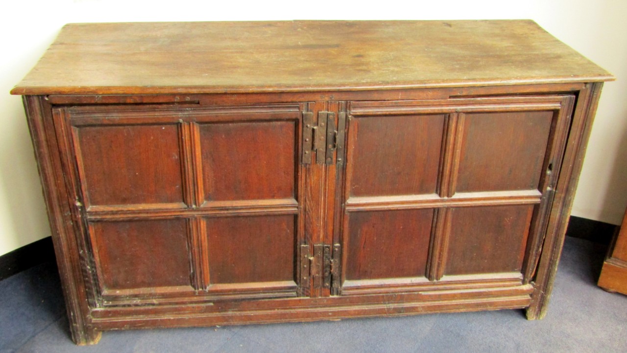 Appraisal: An thC oak cupboard with two quartered panelled doors raised