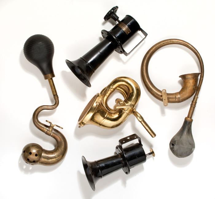 Appraisal: THREE BRASS CAR HORNS AND TWO STEEL CAR HORNS polished