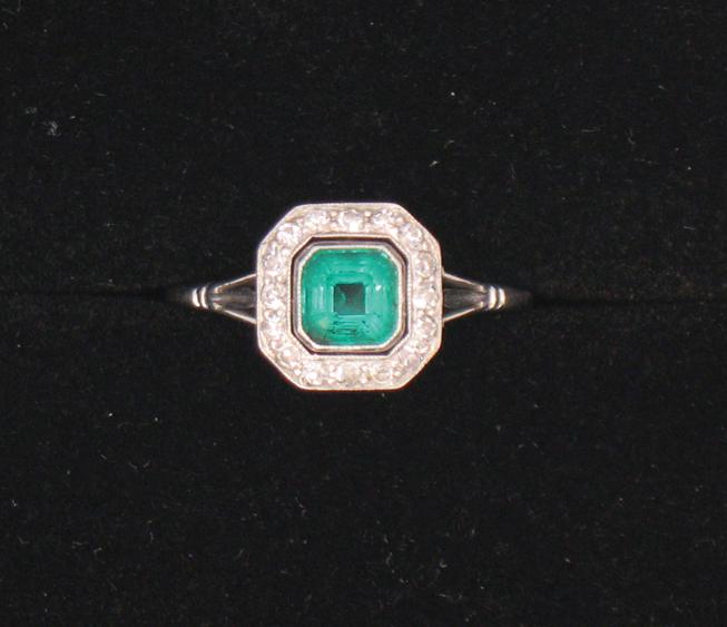 Appraisal: AN EMERALD AND DIAMOND DRESS RING the central canted square-cut