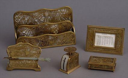 Appraisal: TIFFANY STUDIOS GILT-METAL AND FAVRILE GLASS FIVE-PIECE DESK SET Comprising