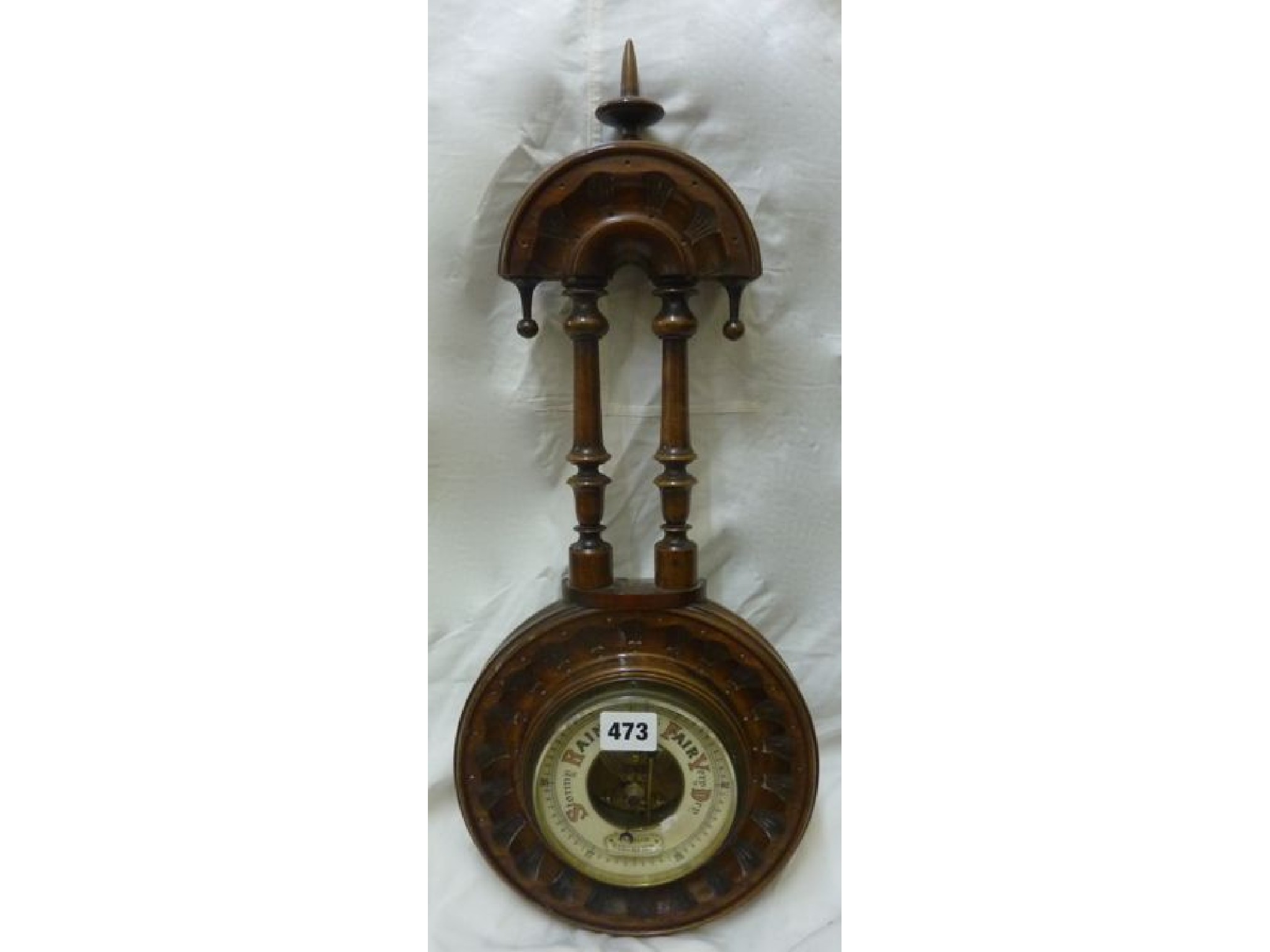 Appraisal: A simple Edwardian aneroid barometer in a carved and moulded