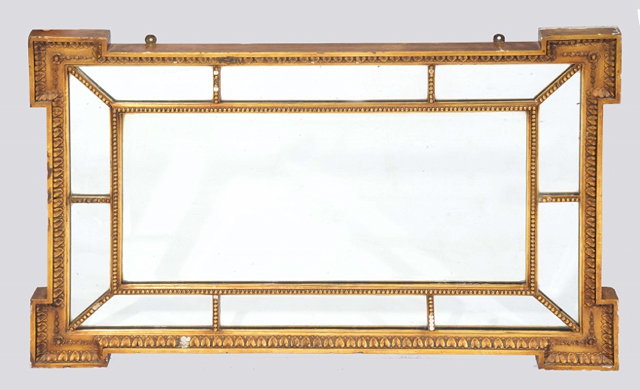 Appraisal: A REGENCY STYLE GILTWOOD HANGING WALL MIRROR with sectional glass