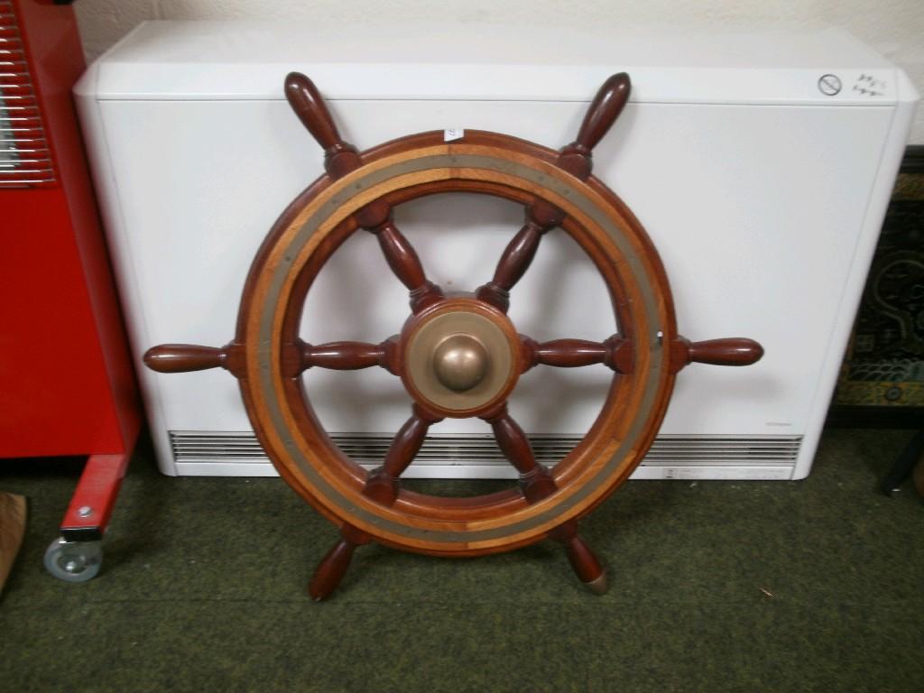 Appraisal: A brass bound mahogany ships wheel with six spoked handles