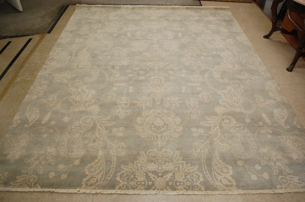 Appraisal: HAND KNOTTED ORIENTAL CARPET featuring a non-traditional overall floral design