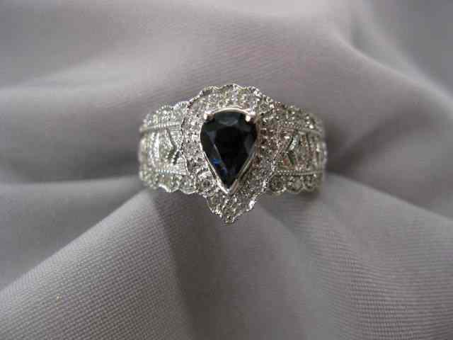 Appraisal: Sapphire Diamond Ring carat pear shaped deep blue gem surrounded