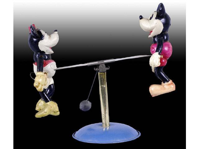 Appraisal: Walt Disney Celluloid Mickey Minnie Mouse Toy Description Tin see-saw