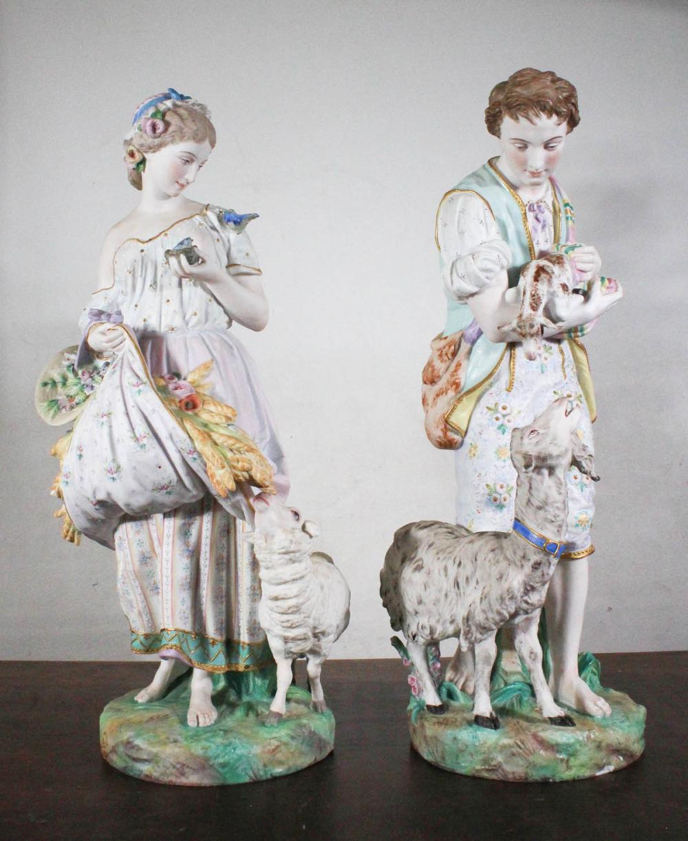 Appraisal: PAIR OF PORCELAIN BISQUE FIGURAL SCULPTURES the standing male with