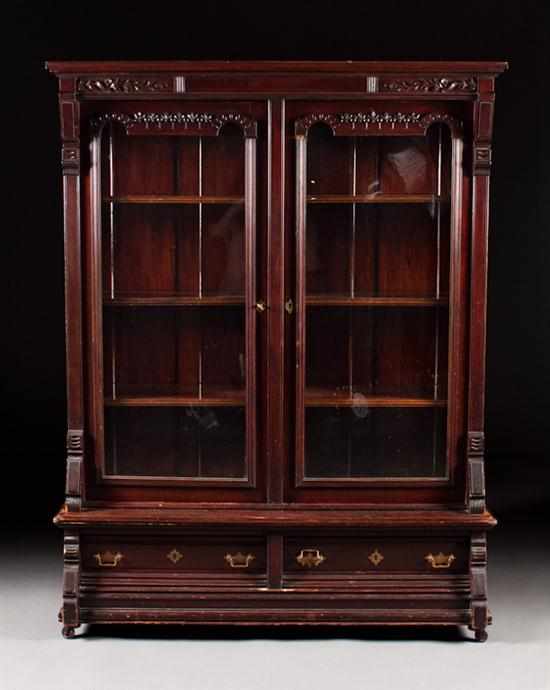 Appraisal: American Aesthetic Movement carved stained wood glass panel two-door bookcase