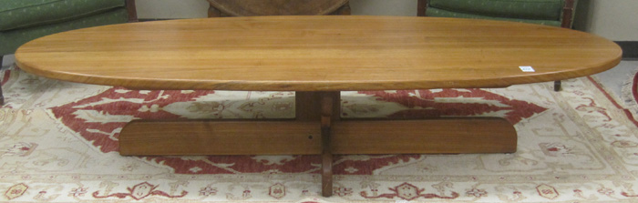 Appraisal: LONG TEAK WOOD COFFEE TABLE th century having an oval