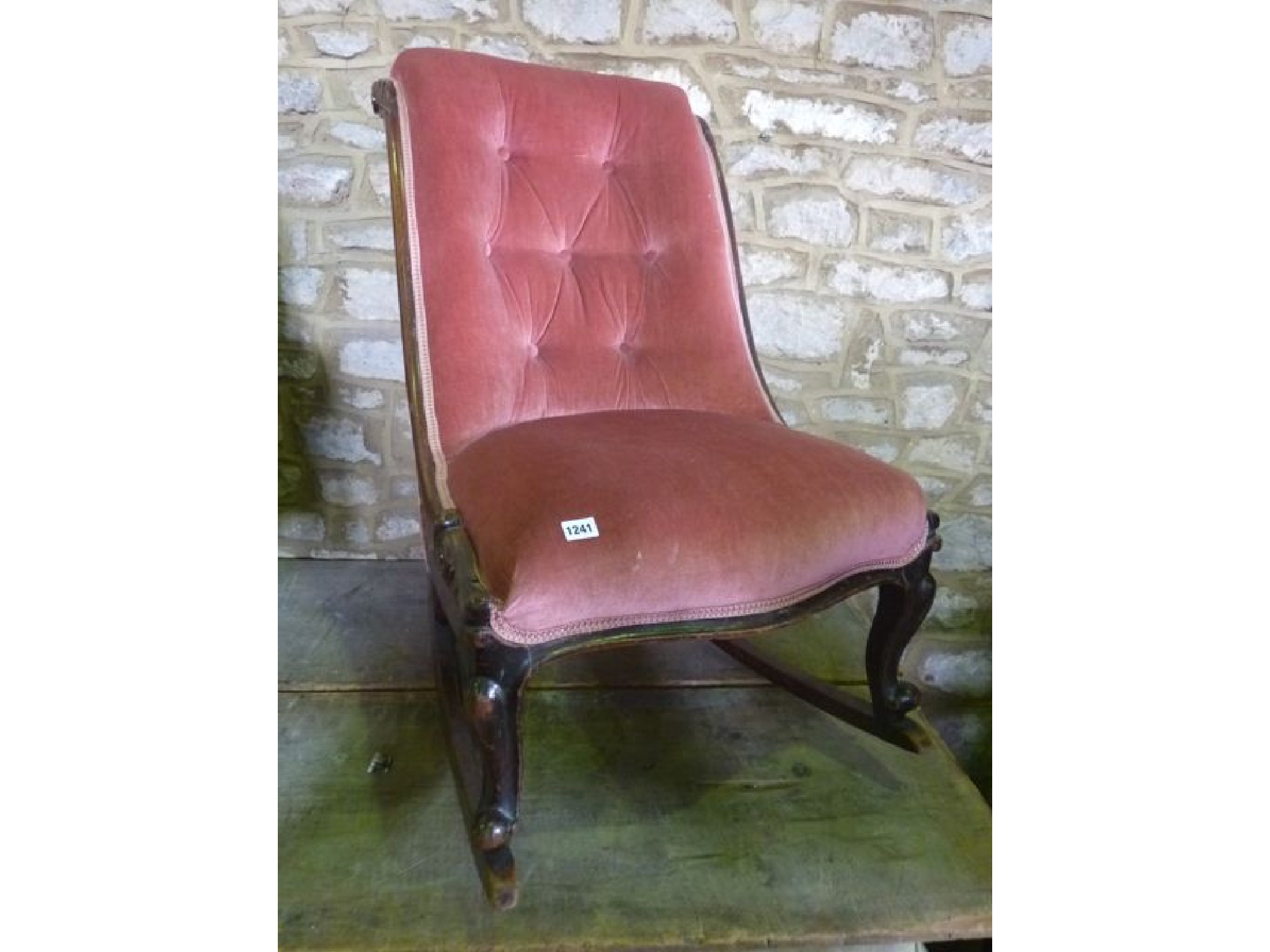 Appraisal: A Victorian low drawing room chair with serpentine upholstered seat