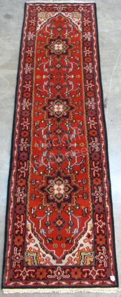 Appraisal: A Handmade Oriental Runner Heriz design red field with blue