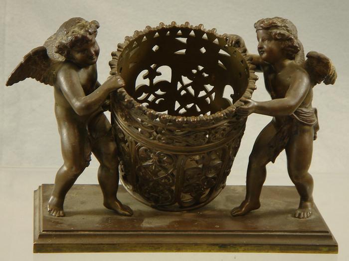 Appraisal: Bronze sculpture two winged cherubs tilting ornate pierced flower holder