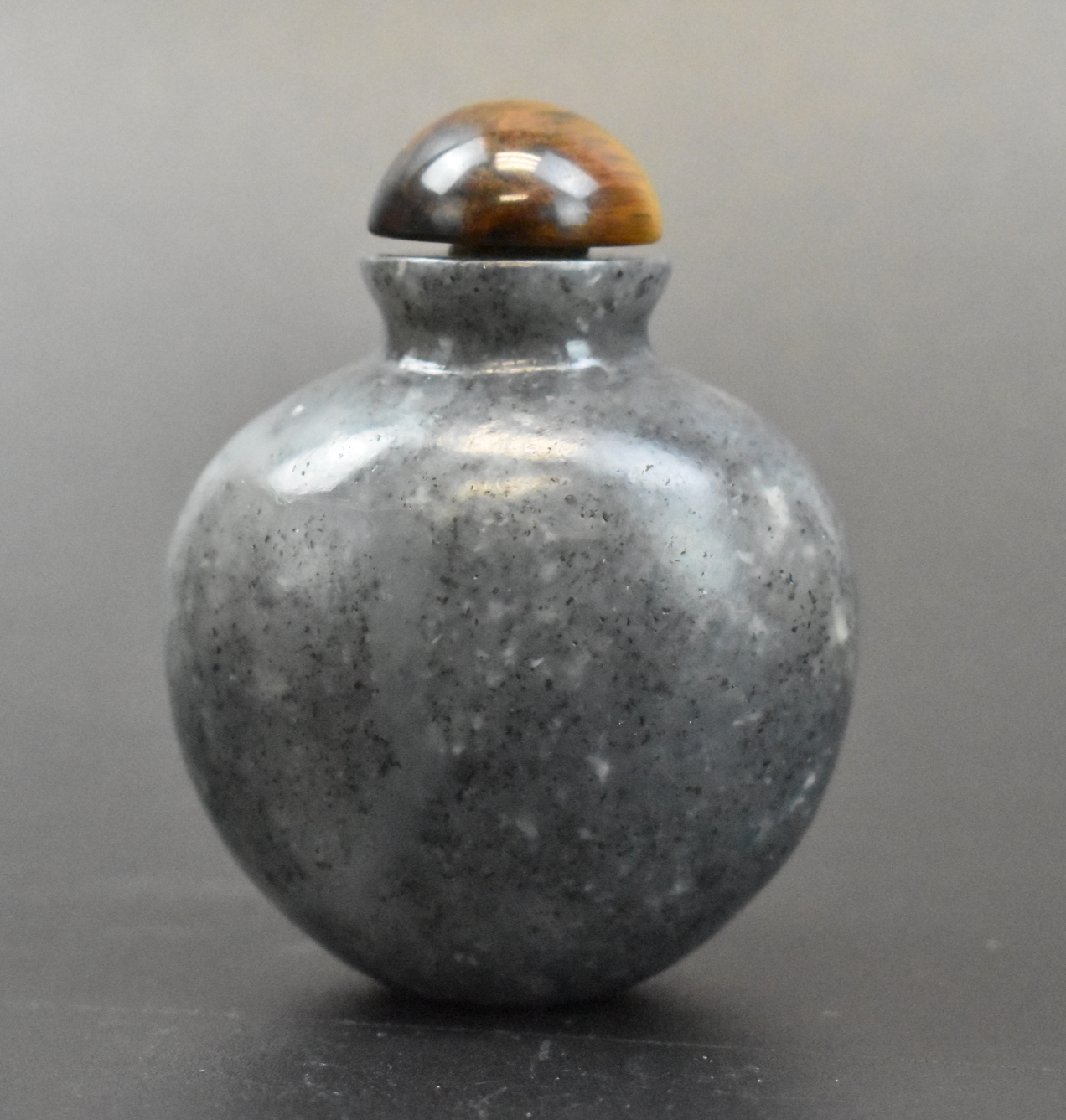 Appraisal: A Chinese grey jade carved snuff bottle dating from the