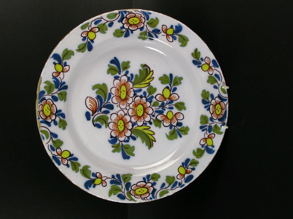 Appraisal: A Delft polychrome Charger floral painted in yellow green blue