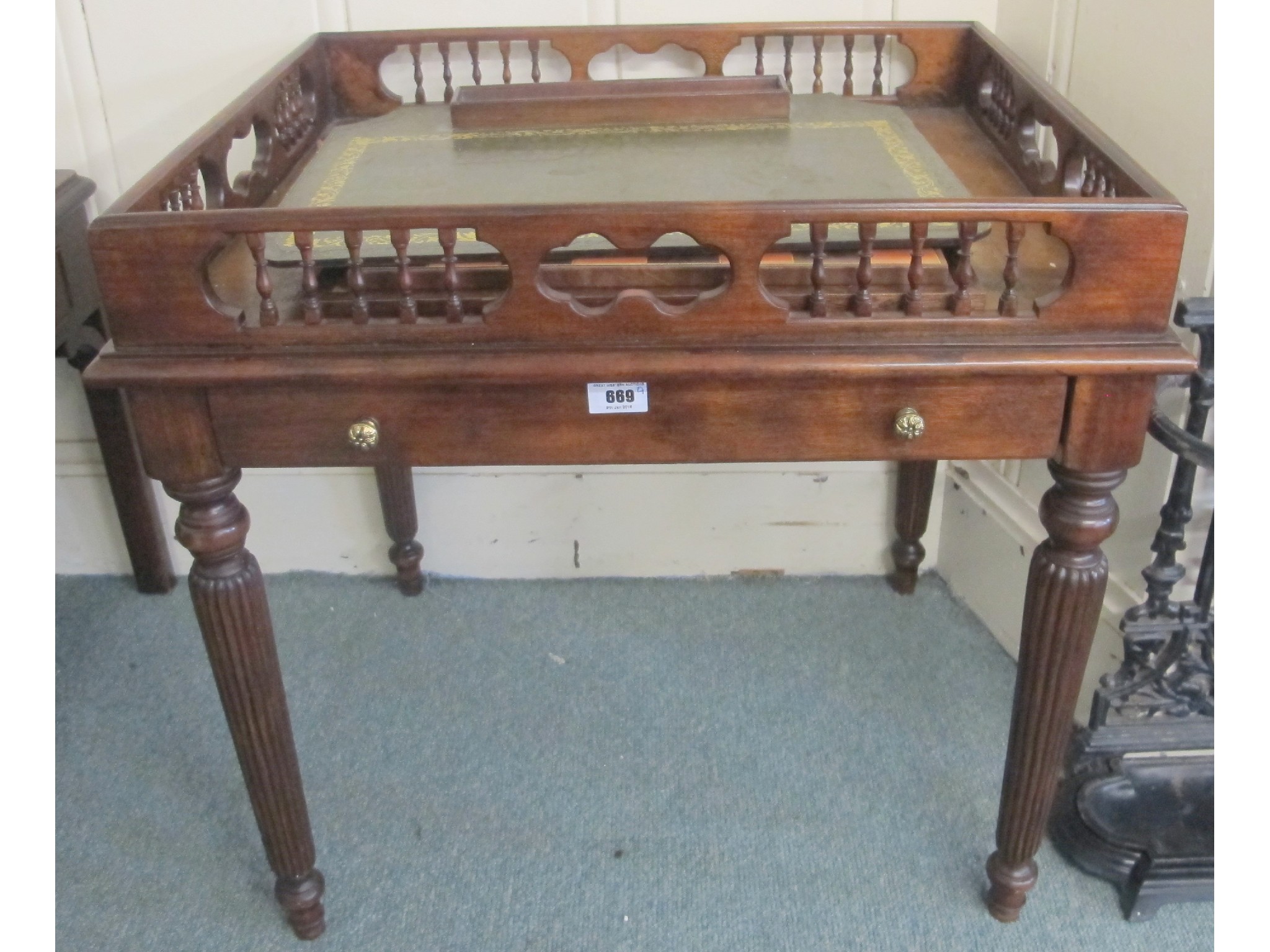 Appraisal: A contemporary mahogany side table with leather top and small