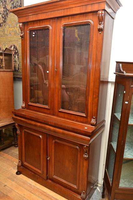 Appraisal: A VICTORIAN CEDAR BOOKCASE CABINET A VICTORIAN MAHOGANY BOOKCASE CABINET