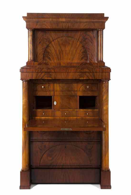 Appraisal: A Biedermeier Flame Mahogany Secretary Chest having a molded cornice