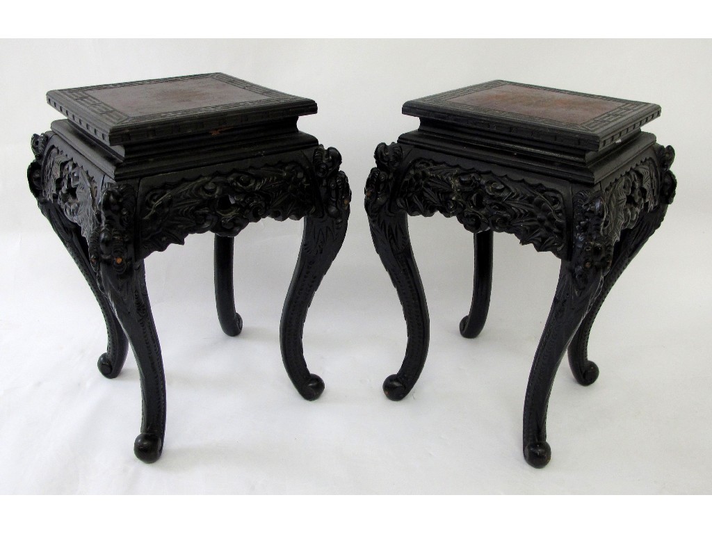 Appraisal: A pair of Chinese carved hardwood plant stands tables richly