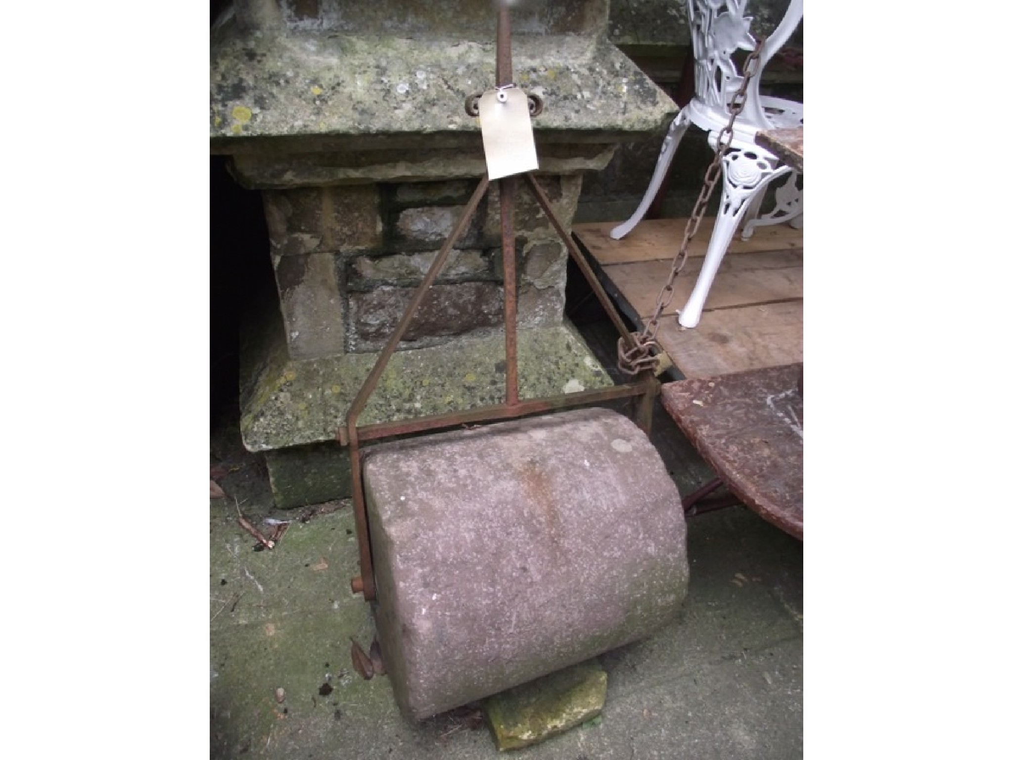 Appraisal: A th century stone garden roller with wrought iron frame