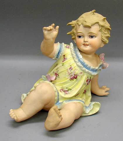 Appraisal: Bisque female child piano style leaning on her hand Molded