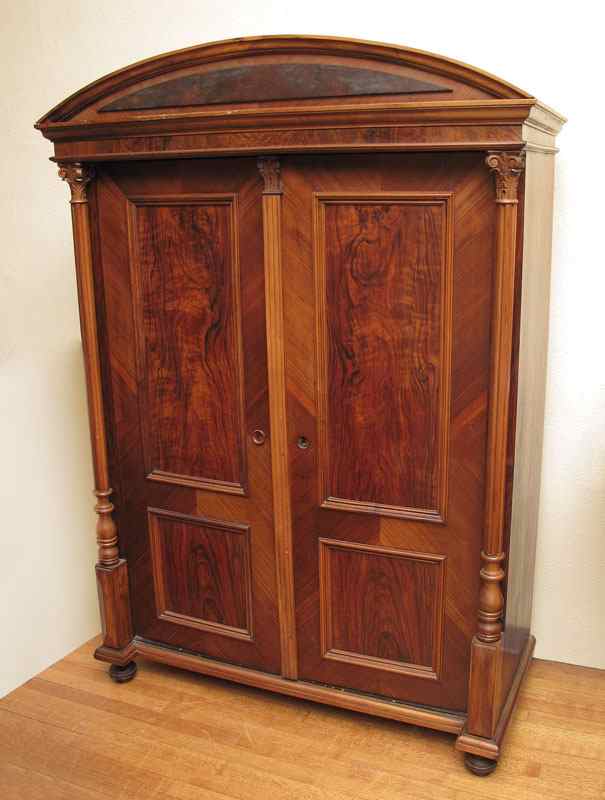 Appraisal: RICHLY GRAINED DIMINUTIVE MAHOGANY ARMOIRE Demi-lune crest carved and turned