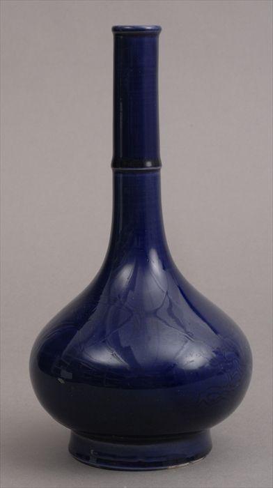 Appraisal: CHINESE COBALT-GLAZED PORCELAIN FOOTED VASE WITH INCISED DECORATION With bamboo