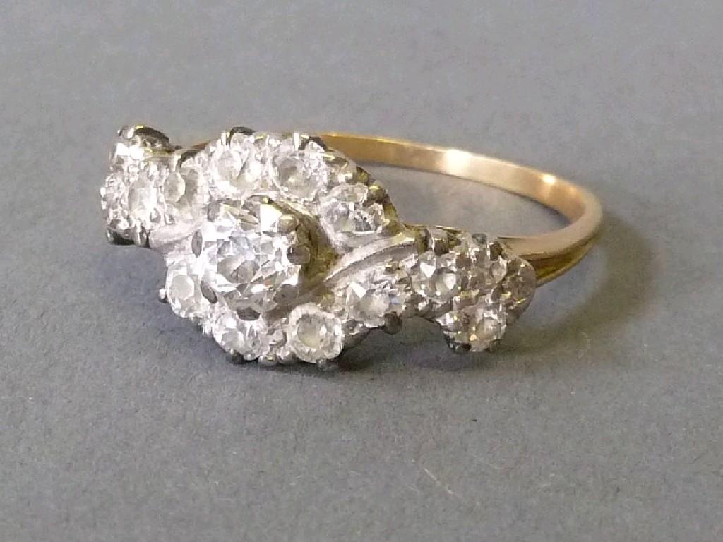 Appraisal: GOLD and DIAMOND CROSSOVER CLUSTER RING the centre old cut