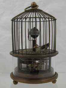 Appraisal: A birdcage novelty clock with visible movement revolving globe and