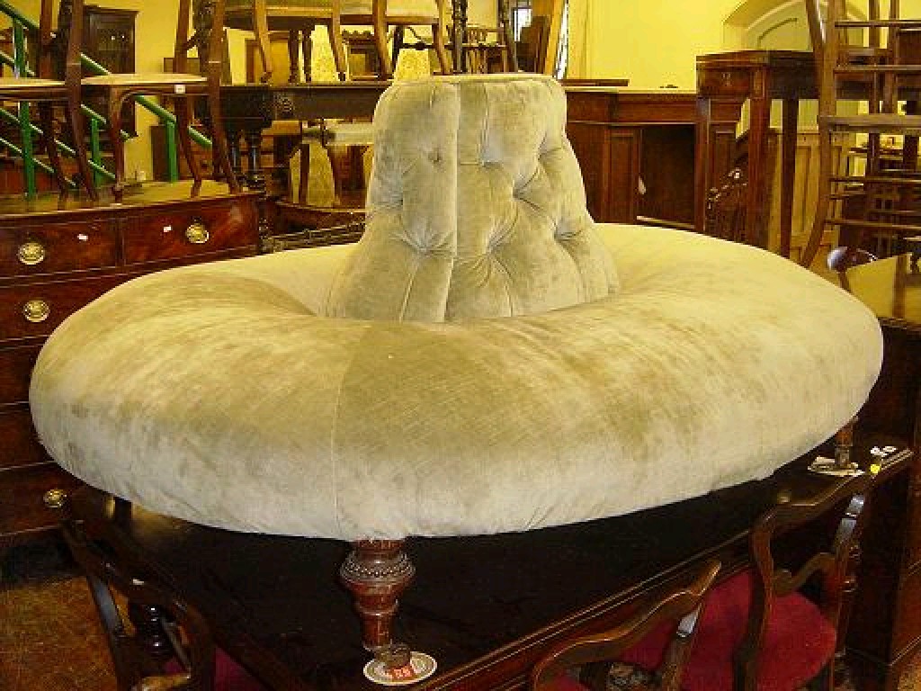 Appraisal: A Victorian conversation sofa with upholstered seat and raised button