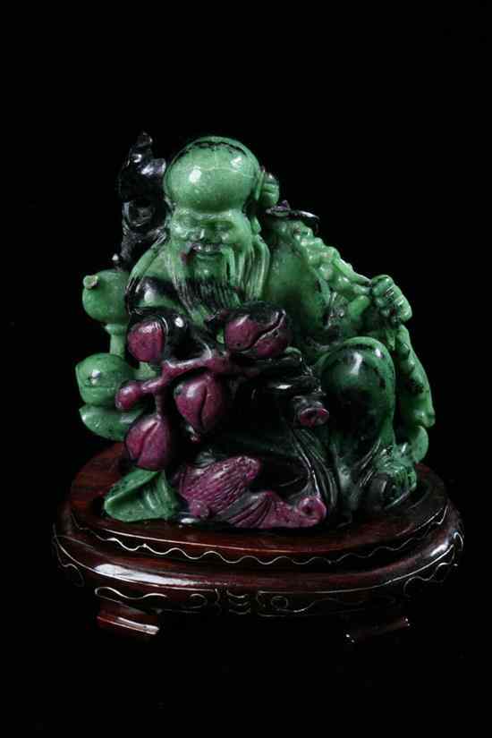 Appraisal: CHINESE ZEOLITE FIGURE OF IMMORTAL Seated at ease holding a